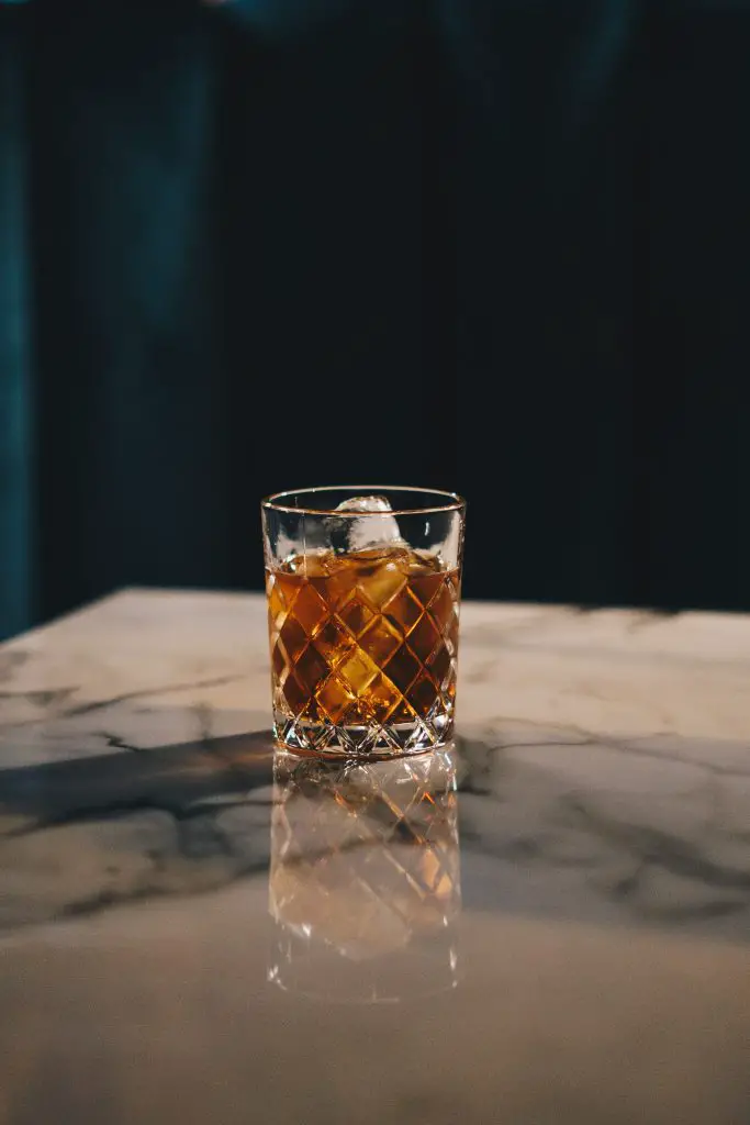 clear drinking glass with yellow liquid